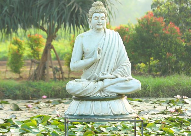 Meditative Buddha Statue in a Garden Pond A Serenity Symbol